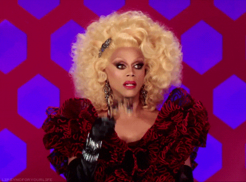 RuPaul in drag using binoculars